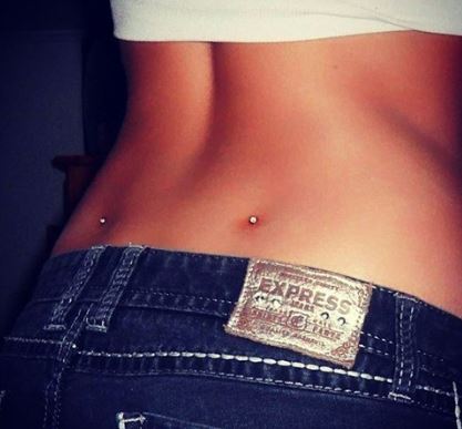 Lower back dimple piercings