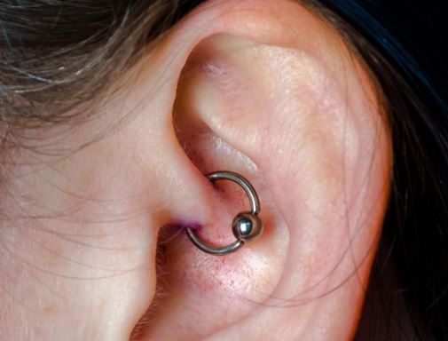 Daith piercing for migraine relief